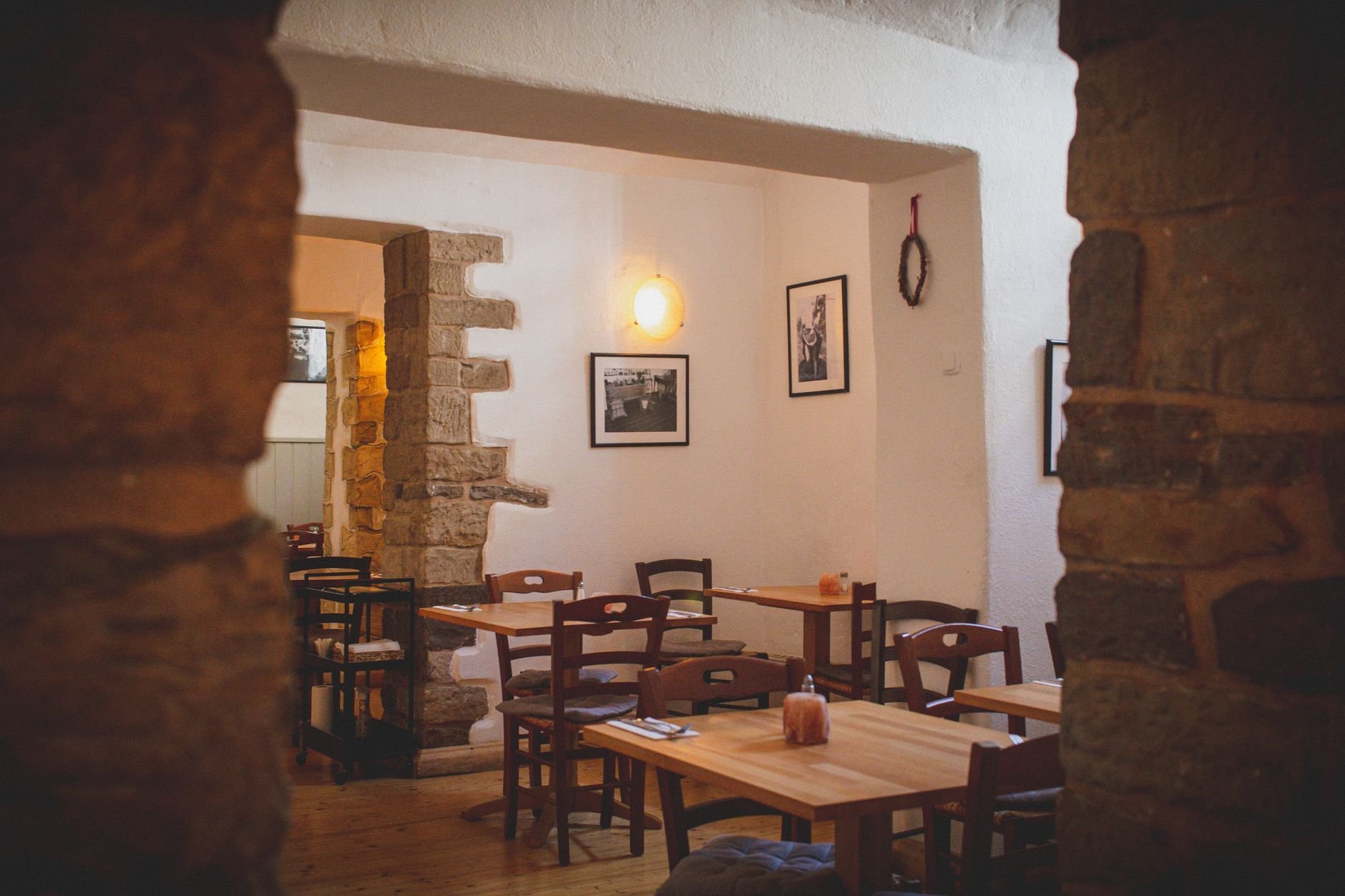 Warm and inviting restaurant interior with rustic wooden tables and candlelight