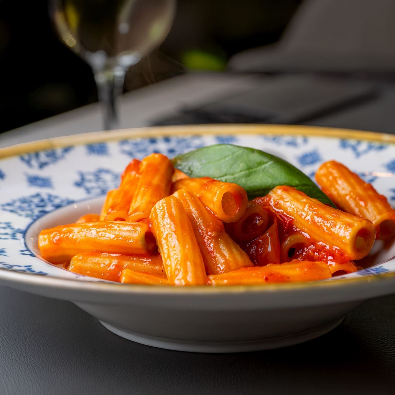 Rigatoni pasta in rich tomato sauce garnished with fresh basil